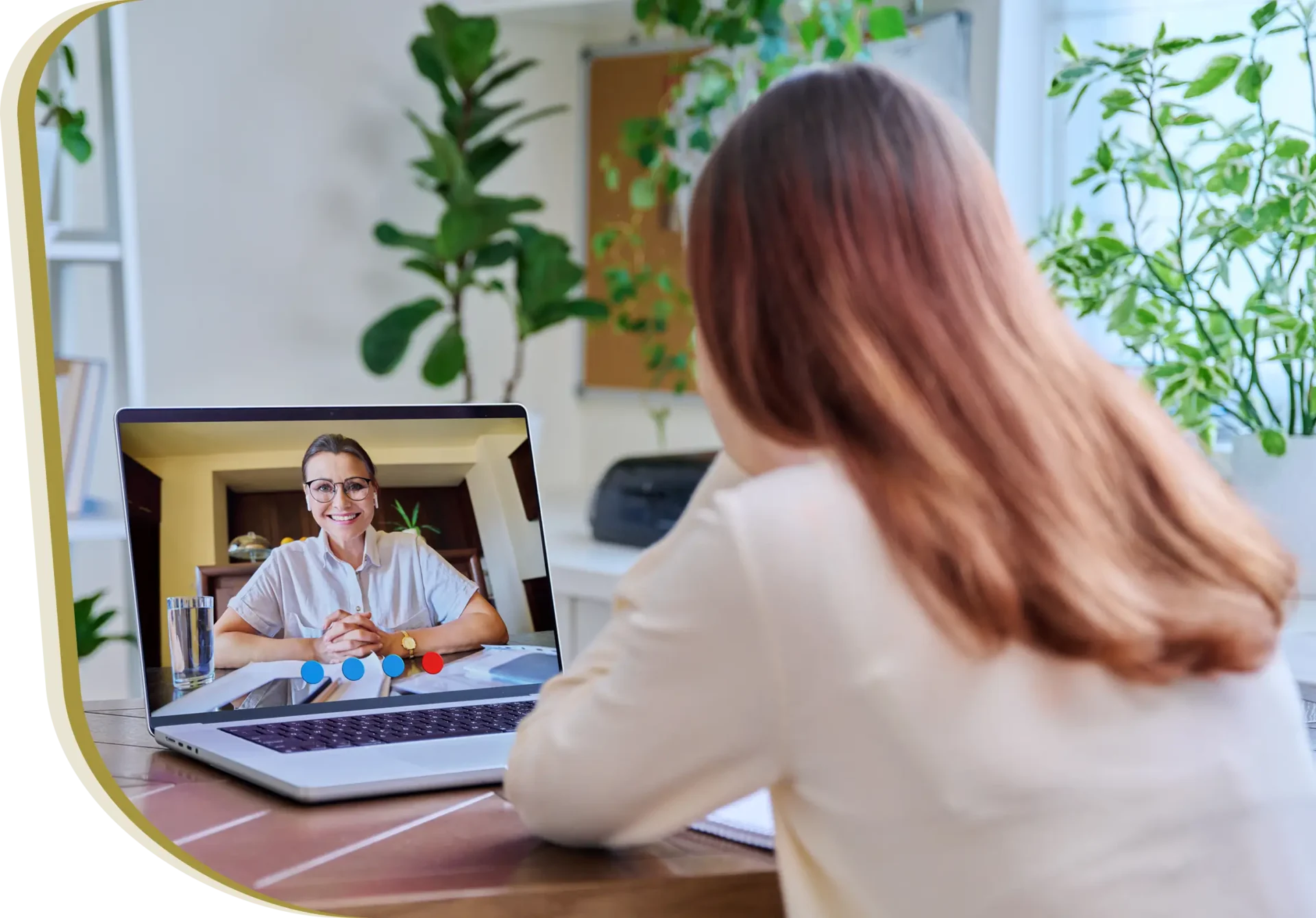 A woman sitting at a table with a laptop.